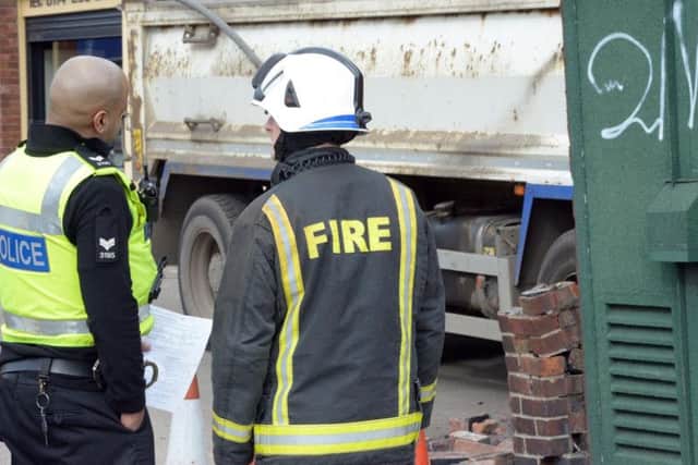 Emergency services inspect the scene. Picture Marisa Cashill/The Star