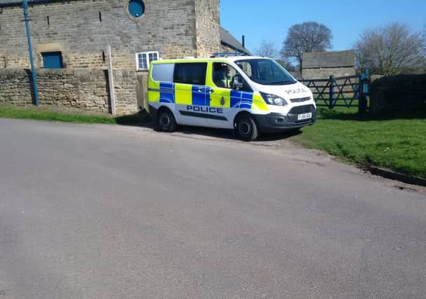 A police van outside Manor Farm in West Handley.