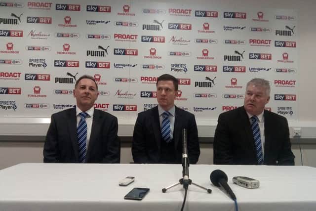 Chesterfield's new boss Gary Caldwell, centre, flanked by company director Ashley Carson, left, and Chris Turner, right