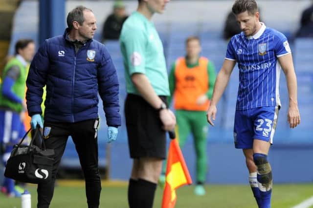 Sam Hutchinson trudges off the field against Norwich with Club Doctor Richard Higgins
