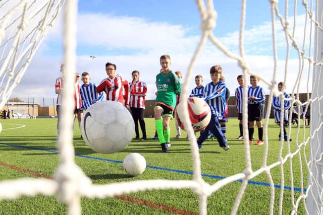 Young footballers having ago with the new facilities at the the opening of St George's Park Graves Parklife football hub in Sheffield. Picture: Chris Etchells
