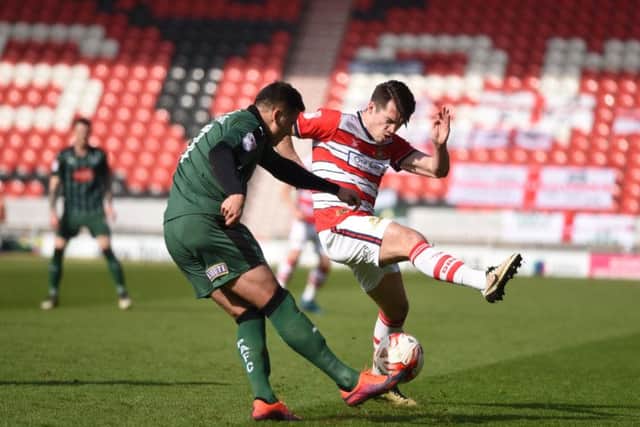 John Marquis gets a block in against Gary Miller in the Doncaster Rovers/Plymouth Argyle match