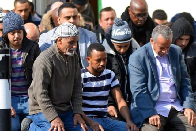 Mourners knelt on mats and bits of cardboard outside the mosque, which was full