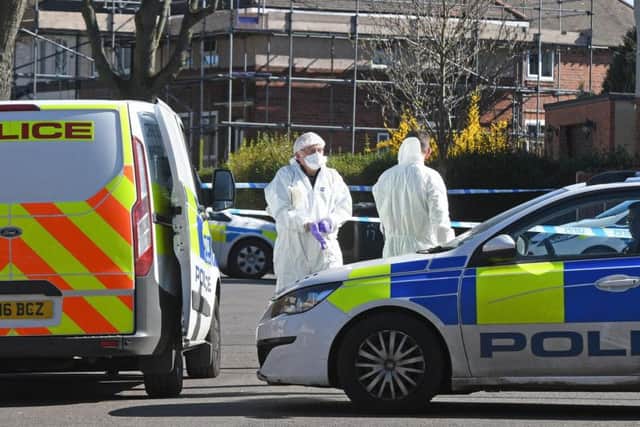 Forencics officers at the scene after a murder probe was launched