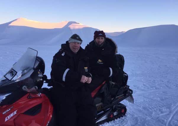 Ben Parkinson, right, on a skidoo in the Arctic with Steve Beard, the chief executive of Pilgrim Bandits