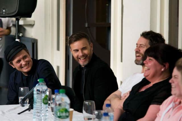 Take That's Mark Owen, left, Gary Barlow and Howard Donald have a laugh at their musical The Band press conference with cast members Rachel Lumberg and Faye Christall, right