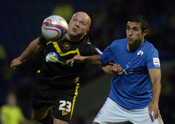Guy Branston, left, pictured when playing for Torquay against Chesterfield, challenges Jack Lester for the ball