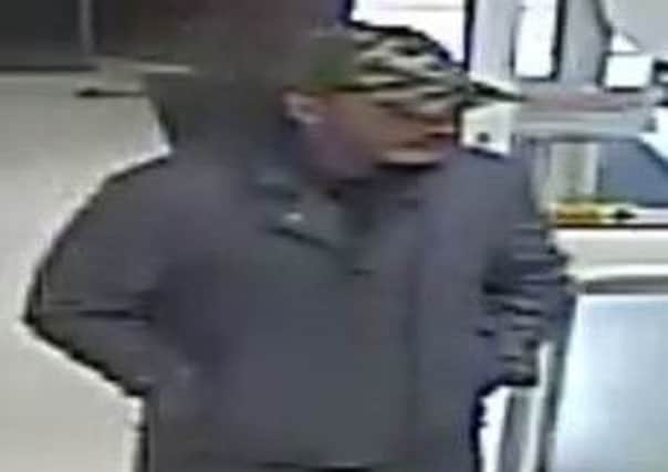Police have released an image of a man, pictured, they would like to speak to as part of an investigation after a purse was allegedly stolen from a pensioner in the Co-op, on Norfolk Street, Glossop, on April 12.