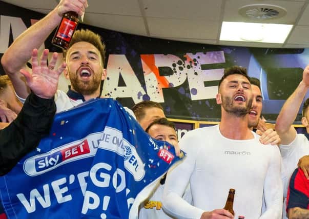 Former Owls players Mark Beevers and Gary Madine celebrate promotion with Bolton