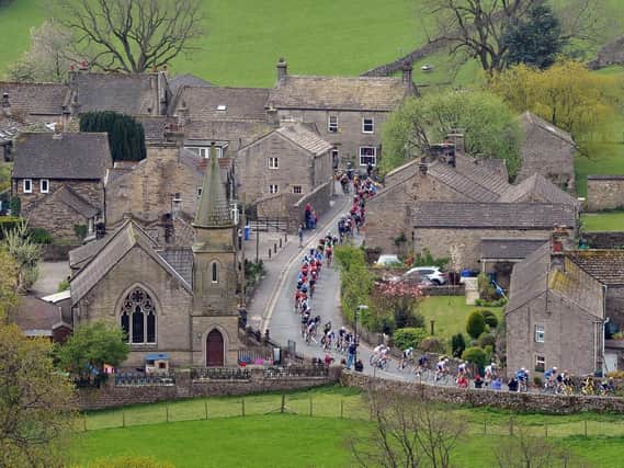 The Peloton passes through Burnsall in the Yorkshire Dales on the last leg of the race from Bradford to Sheffield. Picture: Tony Johnson