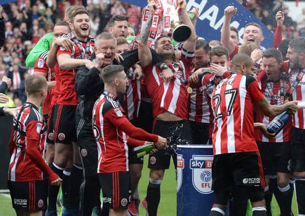 Jay O'Shea sprays his team-mates with champagne having won the League One title