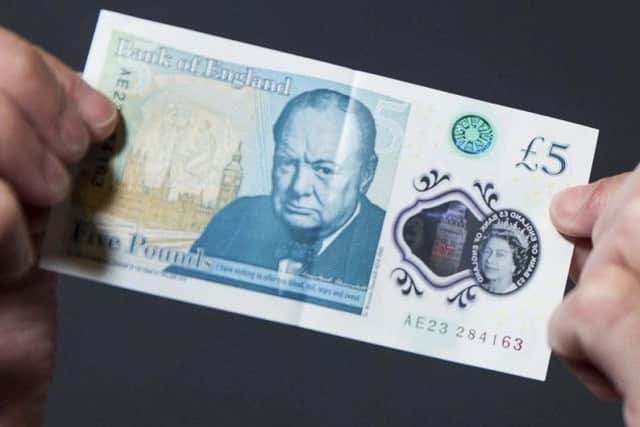 The plastic fiver, which replaced the old paper notes last September