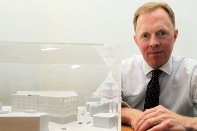 HSBC COO James Emmett with a model of the new building.