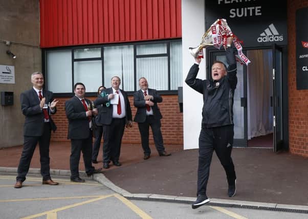 Chris Wilder manager of Sheffield Utd runs out with the trophy before boarding the open top bus from Bramall Lane to Sheffield Town Hall. Pic: Simon Bellis/Sportimage