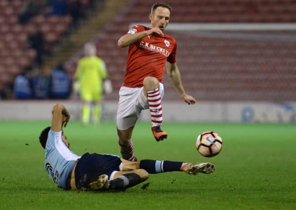 Aidy White jumps a challenge by Kelvin Mellor.
Barnsley FC v Blackpool.  Emirates FA Cup third Round replay.  17 January 2017.  Picture Bruce Rollinson