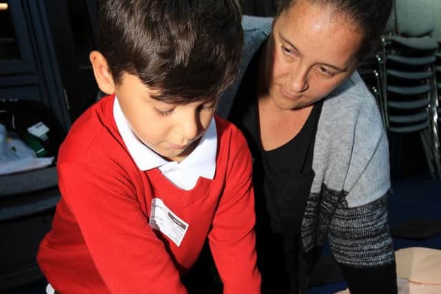 Dan Fagg who suffered a heart attack on a football pitch takes part in Restart a Heart Day at Hayfield School in Auckley. Dan is pictured with mum Hayley Thomson.