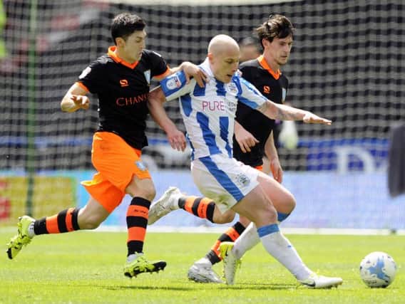 Fernando Forestieri and Kieran Lee gang up on Huddersfield Town's Aaron Mooy