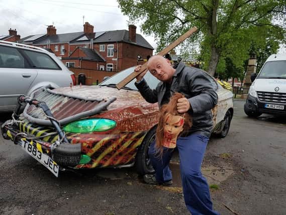 Richard poses beside his new zombie-killer car
