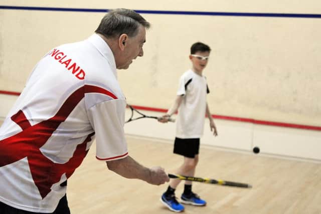 John Robertson puts 10 year old Harley Vickers through his paces at the Brampton Manor squash courts.