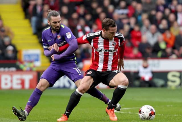 Ricky Holmes of Charlton Athletic in action with Billy Sharp of Sheffield United
