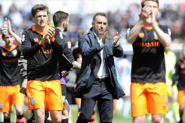 Carlos Carvalhal and his team salute the traveling fans after a draw at Huddersfield in the play-off semi-final first leg