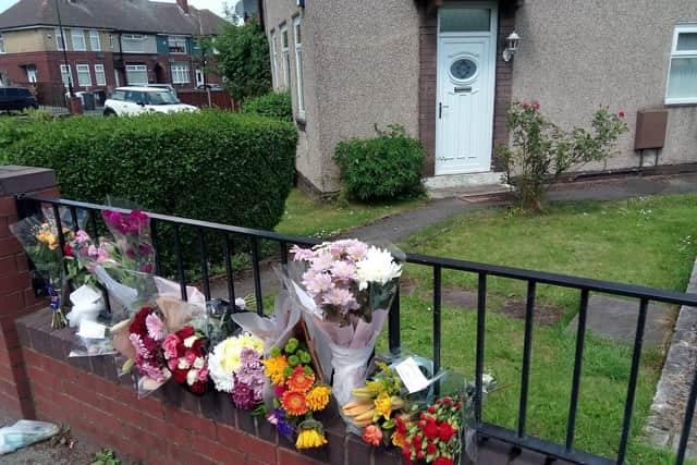 Floral tributes outside Kelly's parents' home.