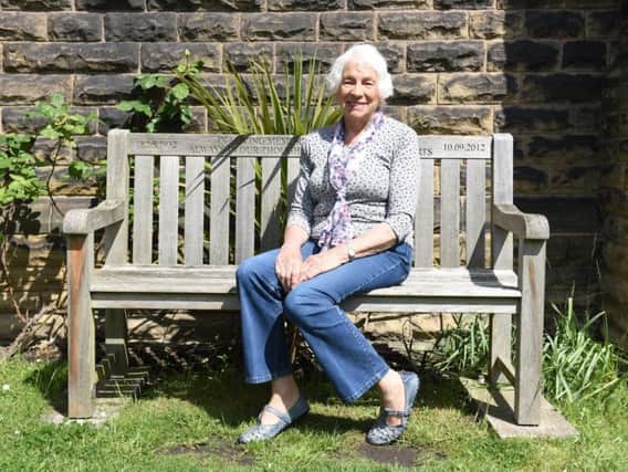 Jean Holland will receive a British Empire Medal for her tireless volunteer work. She is sitting on a memorial seat for husband Harry at St Mark's Church, Mosborough