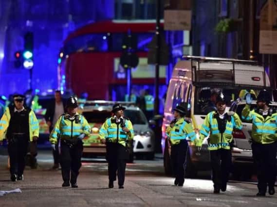 Officers at the scene last night. Picture: Dominic Lipinski/PA wire