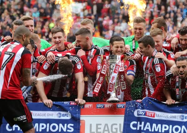 Sheffield United's players celebrate with the League One trophy. Pic David Klein/Sportimage