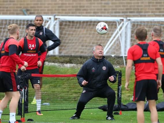 Chris Wilder gets involved in a warm-up exercise during Sheffield United training