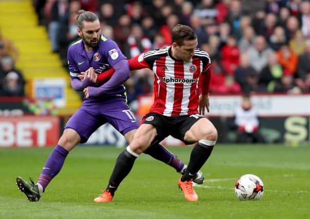 Ricky Holmes of Charlton Athletic in action with Billy Sharp of Sheffield United. Pic: Jamie Tyerman/Sportimage