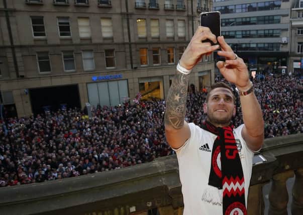 Billy Sharp of Sheffield Utd takes a selfie with the fans during the open top bus parade. Pic: Simon Bellis/Sportimage
