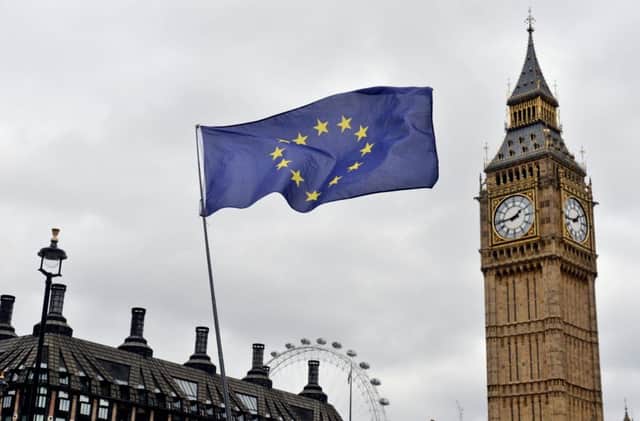 An EU flag flies in front of the Houses of Parliament in Westminster, London Photo:  Victoria Jones/PA Wire