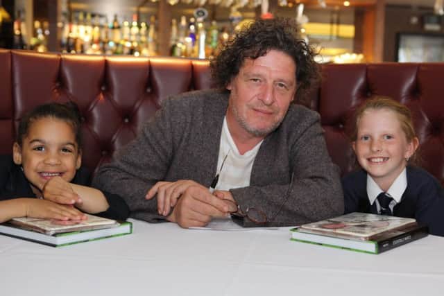 Alicia Nwanko, aged five, (left) and Rhia Haines, aged nine, (right), primary school pupils from St Marys C of E Academy, Walkley, who created a pizza for chef Marco Pierre White at his New York Italian restaurant, West Bar Green, Sheffield.