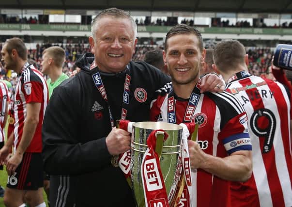 Chris Wilder and Billy Sharp celebrate United's League One title triumph