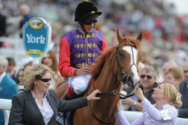 The royal colours of the Queen, sported here by Frankie Dettori, which could be carried to success at Ascot on the final day of the meeting by Dartmouth in the Hardwicke Stakes.