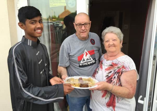 Ikram Rahman, aged 13, a pupil at Handsworth Grange Community Sports College, shares iftar with his neighbours  Jennifer and Raymond Needham as part of the Know Your Neighbour campaign.