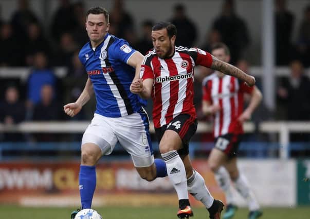 Samir Carruthers of Sheffield Utd tussles with Harrison McGahey of Rochdale. Pic: Simon Bellis/Sportimage