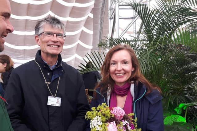 Sage Greenfingers trustee Dr Will Carlile and staff member Emma Msisgiti collect their silver medal at RHS Chatsworth Flower Show.