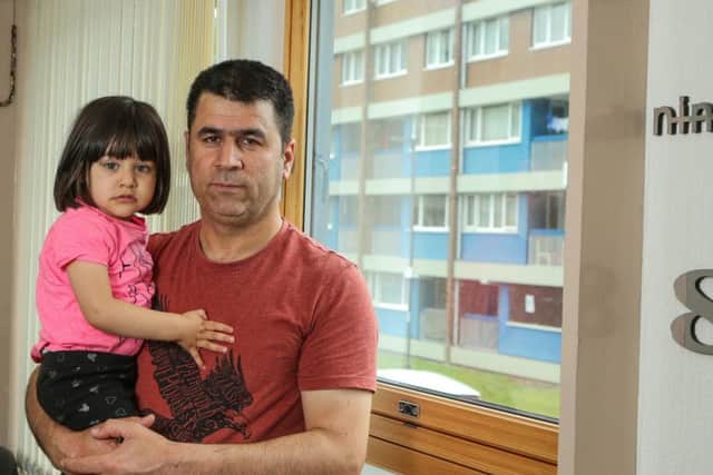 Aram Salih, 41, a taxi driver, with his youngest child, Atina, two, at their home in Hanover Tower.. The cladding on the 16 story block in which he lives has failed a government safety test and in the wake of the Grenfell tragedy, Mr. Salih says he fears for his safety and that of his family. Picture: Benjamin Paul/SWNS