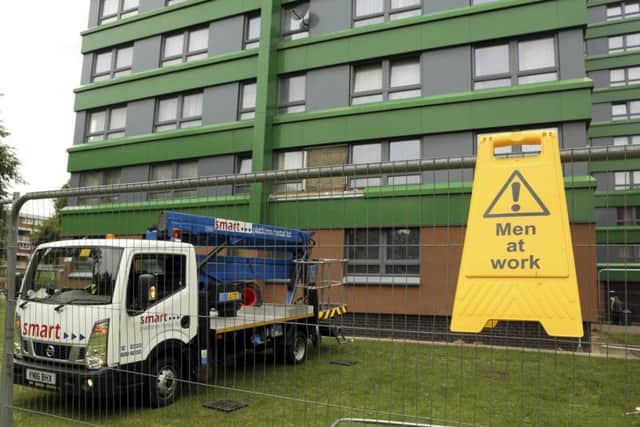 Cladding on the Hanover Tower block in Sheffield is taken down after it failed a fire safety test. Sheffield Council said a single element of covering on the Hanover tower block in Exeter Drive, Broomhall, failed the inspection. Picture: Benjamin Paul/SWNS