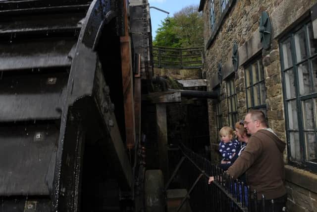 Rol Smith, Laura Sturt and Eleanor Sturt look at the water wheel to celebrate national mills weekend and vintage power at Abbeydale Industrial Hamlet. Picture: Andrew Roe