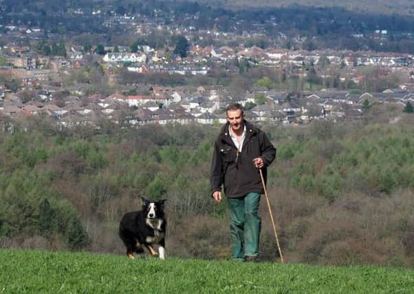 Farmer Nick Denniff: with sheepdog Ben in one of his fields above Totley
