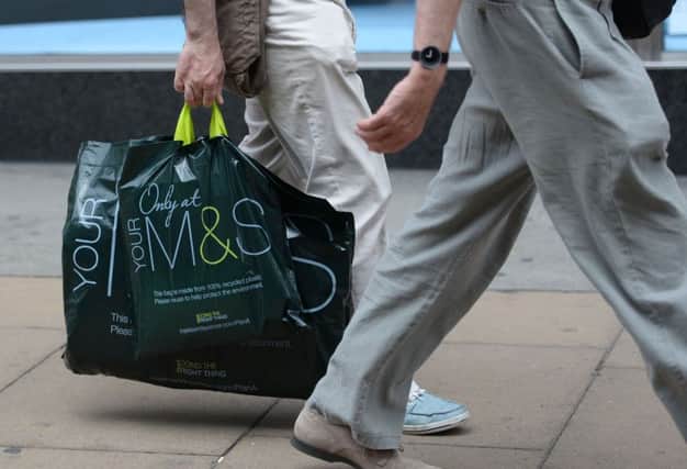 File photo of a person carrying a Marks and Spencer carrier bag near Marble Arch, London, as the retail giant reported an improvement in its under-pressure clothing arm as the timing of Easter helped narrow sales falls. PRESS ASSOCIATION Photo. Issue date: Tuesday July 11, 2017  Photo: Stefan Rousseau/PA Wire