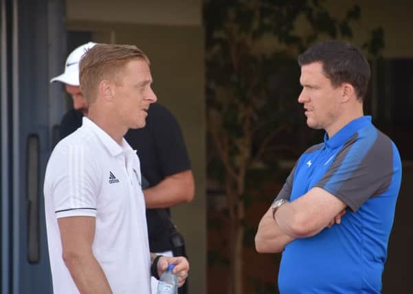 Managers Garry Monk and Gary Caldwell conversing before the game