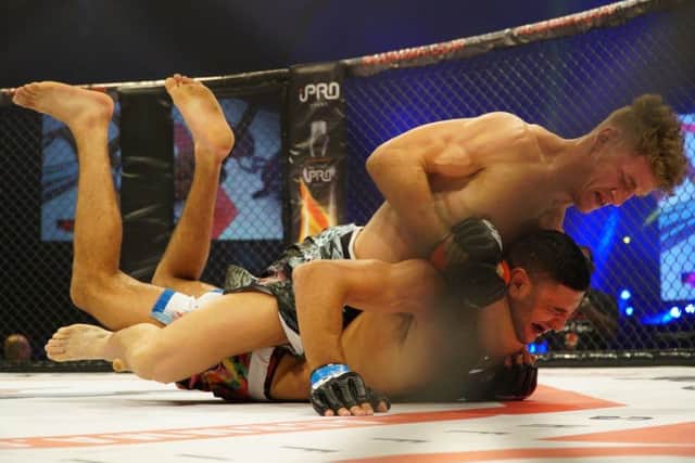 Chesterfield MMA fighter Sam Boult clinches a choke to win at ACB65 at Sheffield Arena