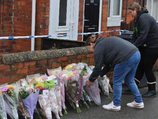Mourners lay tributes near to the towpath where 16-year-old Leonne Weeks was murdered in Dinnington