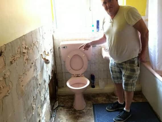 John Furniss-Wright, 59, in the squalid bathroom. Photo: SWNS