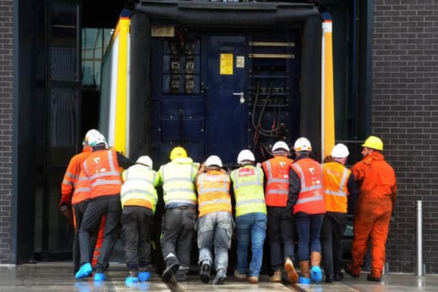 A Eurostar power car engine is manhandled into place after being delivered to the High Speed Rail College in Doncaster.