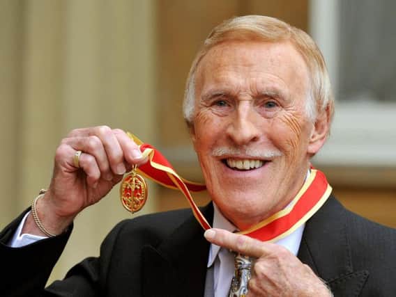Sir Bruce Forsyth after he was knighted by Queen Elizabeth II during an Investiture ceremony at Buckingham Palace, London.
